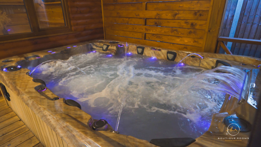 A wooden hot tub outside of our wooden cabin accommodation in St Neots, The Retreat.