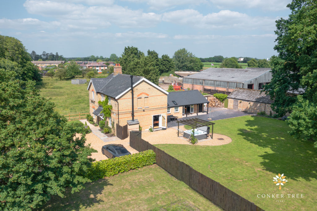 Aerial view of Conker Tree farmhouse in Cambridgeshire, set in countryside fields.